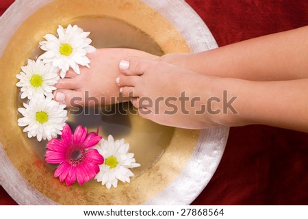 Woman washing her feet in a bowl of water