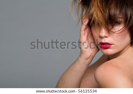 Beautiful young woman with short messy hair and red lips