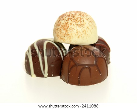 Three chocolate truffles and one white chocolate truffle.