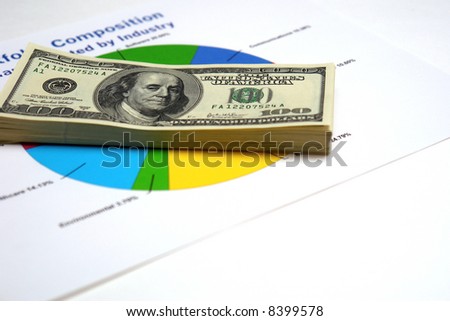 Stack of money on generic financial pie chart