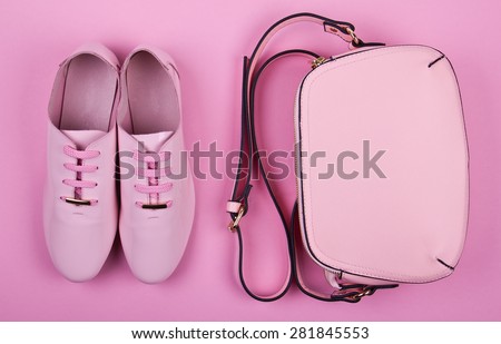 beautiful women's minimal set of fashion accessories on a pink background: shoes and handbag.