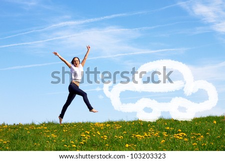 smiling young girl jumping against blue sky is pleased about her first car