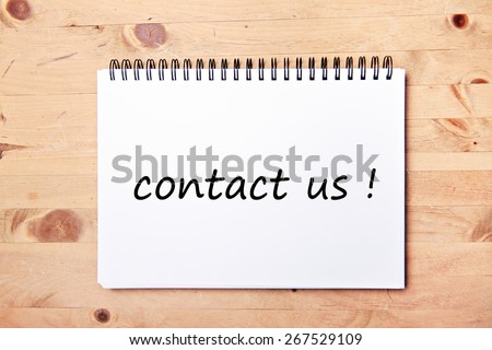 writing pad on wood table  - contact us