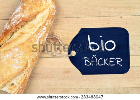 food background - baguette bread on wood table - german for bio baker