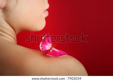 beauty portrait of a young woman with a butterfly on her shoulder - focus on the lips