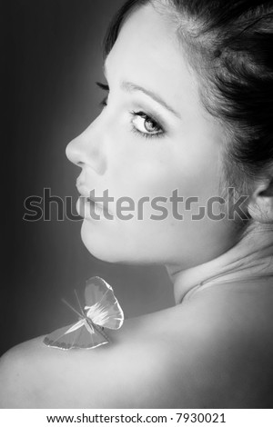 beauty portrait of a beautiful young woman with a butterfly on her shoulder
