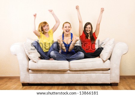 Three young beautiful women are cheering on a lounge
