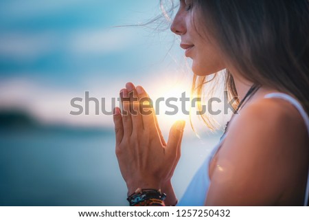 Young woman meditating with her eyes closed, practicing Yoga with hands in prayer position.   ストックフォト © 