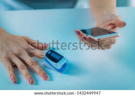 Similar – Finger with pulse oximeter