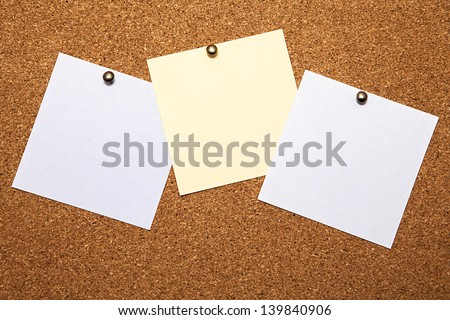 Three sheets for notes on a cork board