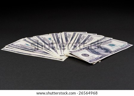 Pile of dollars against a dark background