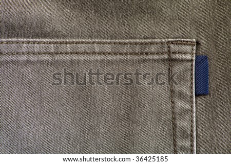 Hip-pocket on grey jeans close up