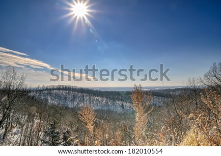 Missouri Ozarks rolling hills covered in snow with the sun shining
