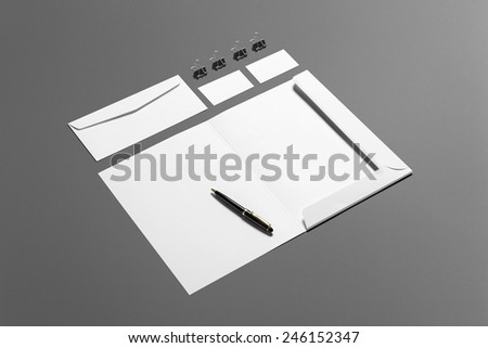 Blank stationery branding set isolated on grey. Consist of business cards, pen, money clips, envelopes, folder.