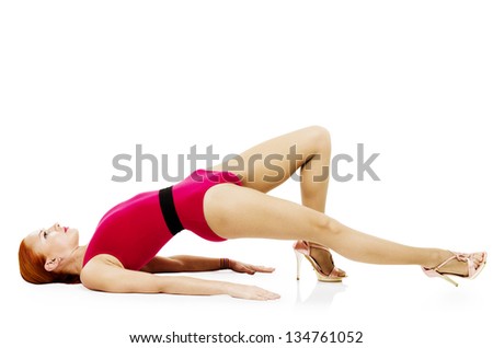 Beautiful fitness model practicing yoga asana wearing high heels