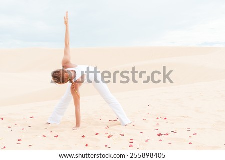 Young woman practicing yoga in the desert