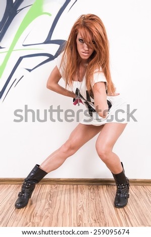 Cool female redhair hip-hop dancer at the dance studio