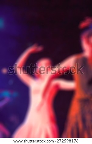 Night of flamenco dancing in a club blur background with shallow depth of field bokeh effect