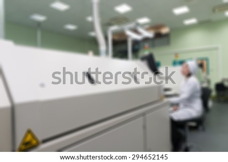 Production of electronic components  at high-tech factory blur background with bokeh