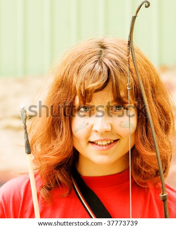 Portrait of a red-haired girl with bow and an arrow