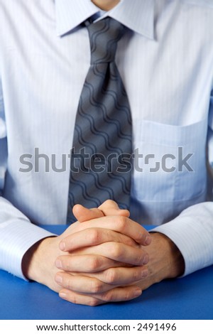 Businessman. Hands clasped.