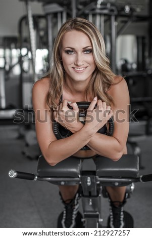 Blonde woman abs exercise with additional weight