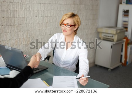 Young blonde businesswoman handshake with client in office, insurance