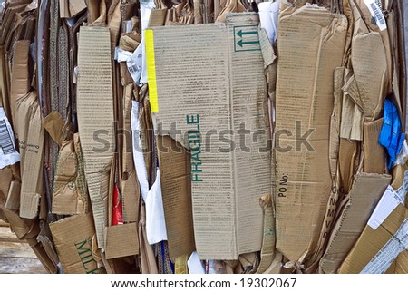 Cardboard waste bundled for recycling; background/texture