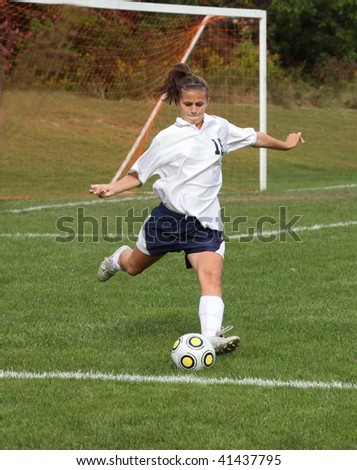 Teenage Girl Ready to Kick Soccer Ball