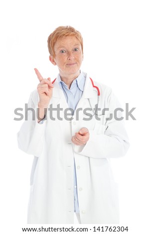 portrait of an elder female doctor standing, wearing a white lab coat and a red stethoscope, pointing with her forefinger and explaining
