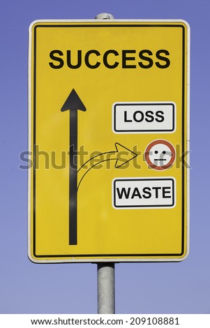 blue sky behind a yellow road sign with an vertical arrow pointing to success and a second arrow pointing to loss and waste at the right hand side.