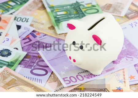 white piggy bank placed on Euro banknotes, concept for cut in interest rates, euro crisis, saving