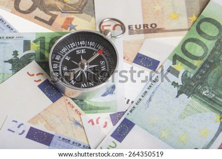 magnetic compass on euro banknotes. financial concept for the trend of the euro exchange rate,  inflation or deflation