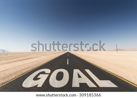 black asphalt road in the desert leading to the  goal. Business concept for success and motivation