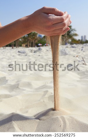 hand pours sand