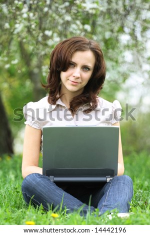 The girl with laptop on the nature