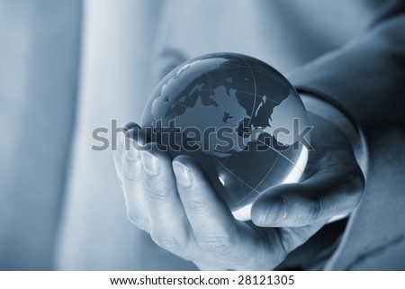 businessman holding mini globe