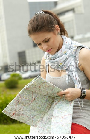 traveler girl searching for her destination on the map