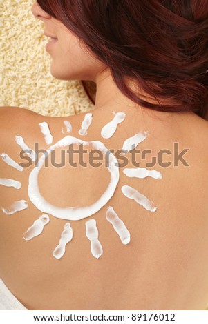 woman with sun-shaped sun cream