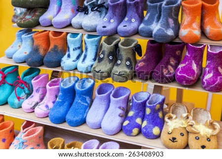 Colorful child felt boots displayed in market