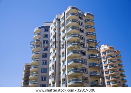 modern residential district with beautiful glass balconies on a background blue sky
