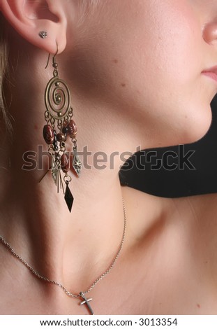 Earring on a young girl\'s ear.