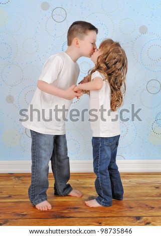 sweet young brother and sister sharing a kiss