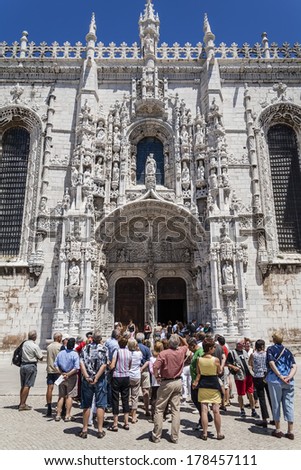 Lisbon, Portugal - June 30, 2013: a guided tour for tourists observing the South Portal of the Jeronimos Monastery, a masterpiece of the Manueline Art