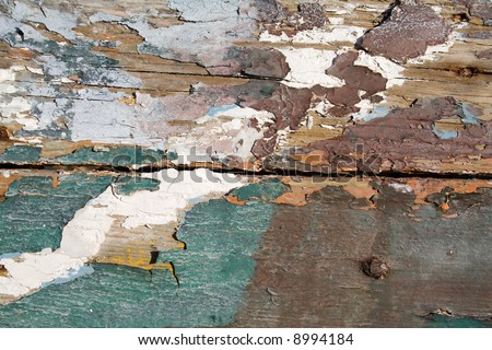 peeled paint over wood boards from a boat hull