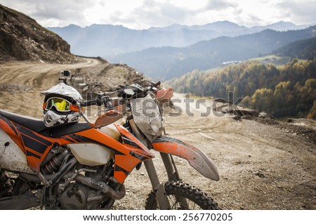 Dirty motorcycle motocross helmet on road