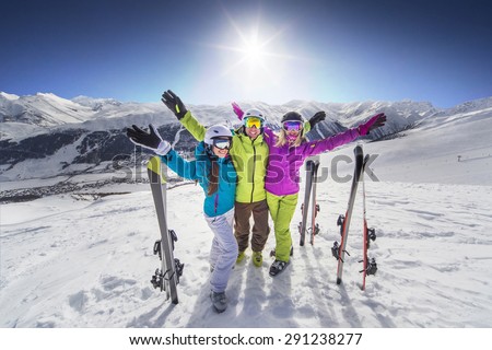 Smiling girl in blue jacket skiing alps resort