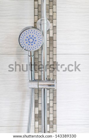 Chrome shower head on wall