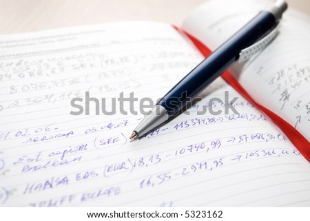 blue pen on agenda book with red bookmark