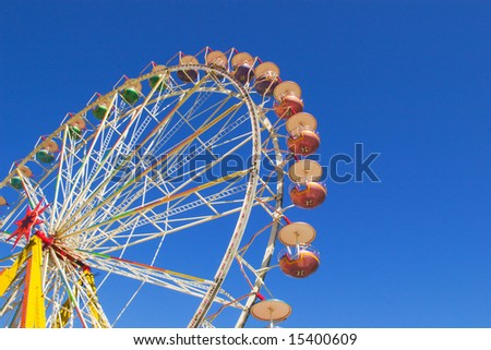 big observation wheel under blue skies